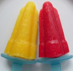A yellow and red ice lolly on a plate