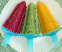 A red, green and orange ice lolly displayed on a plate